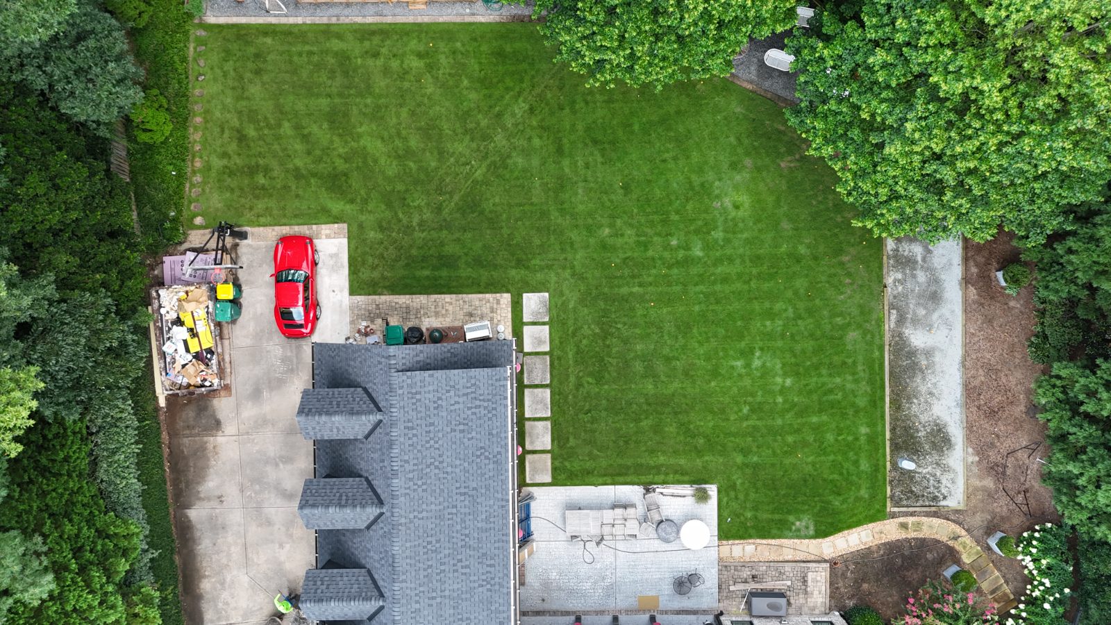 Same front-yard lawn after soil-first treatment, thick and green